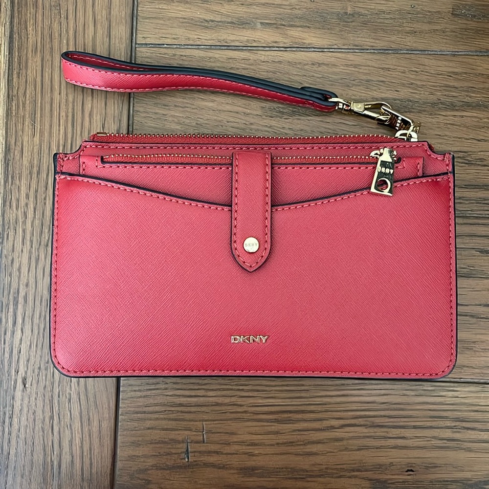 DKNY red wristlet. Has extra card holder that comes out n the front. Like new!